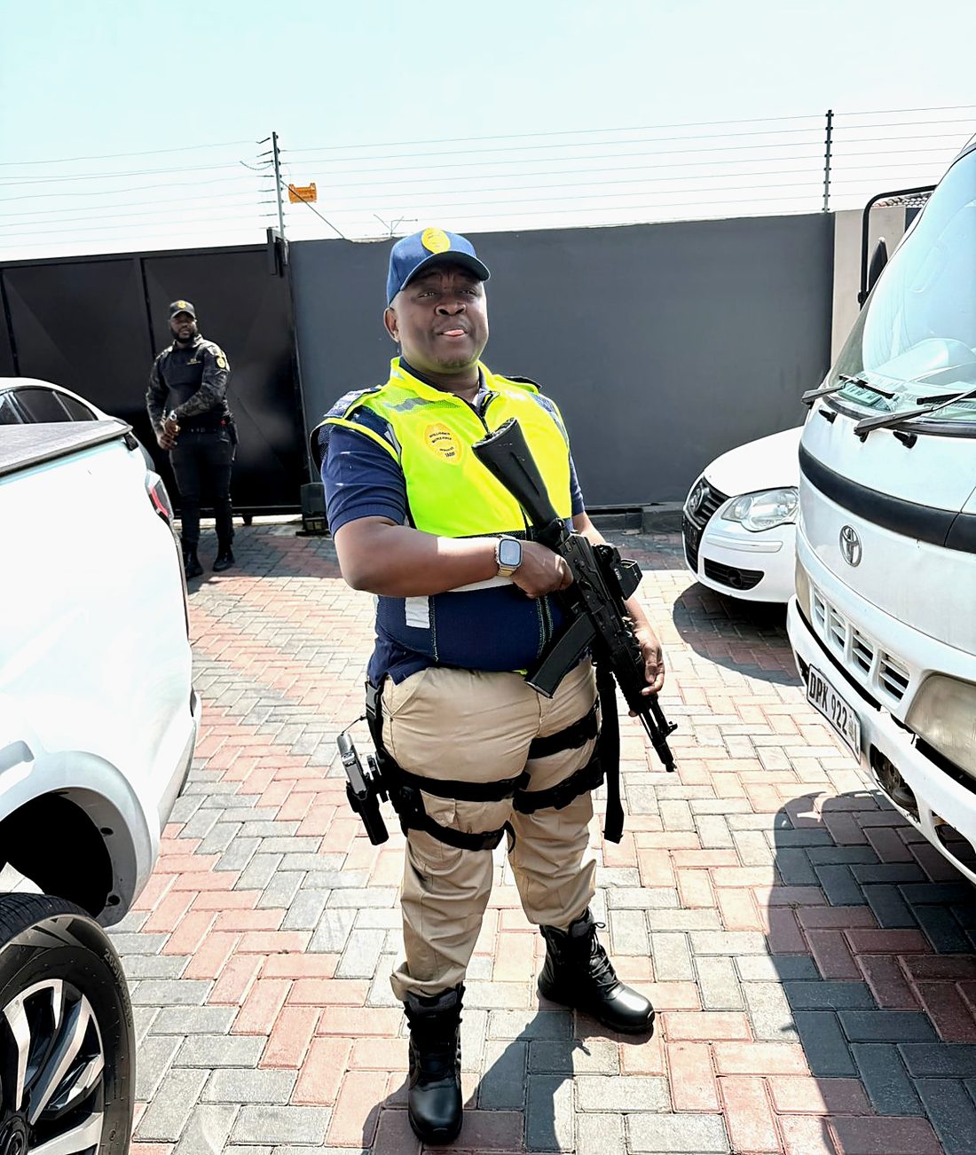 IMF officer beside a client vehicle